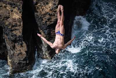 Jonathan Paredes of Mexico dives from a 27m cliff face during the fourth stop of the Red Bull Cliff Diving World Series in São Miguel, Azores, Portugal on June 22, 2019.