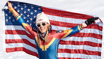 Alpine skier Mikaela Shiffrin celebrates on the podium with the American flag in Crans Montana, Switzerland