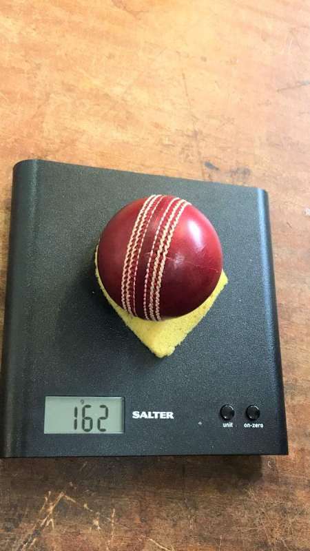 Dukes cricket balls placed on a scale to check their weight.