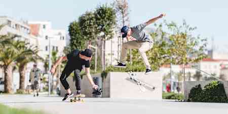 A skateboarder gets video recorded by a cameraman on a skateboard