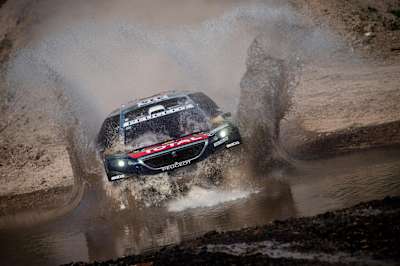 Sebastien Loeb battles through tough conditions