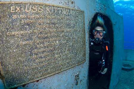 A diver coming out of the insideof the shipwreck.