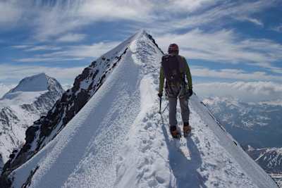 Climber Will Sim on the summit ridge of the Eiger in Switzerland