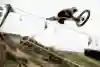 Finn Isles launches off jump during practice at the UCI MTB Downhill World Cup at Les Gets, France, on July 11, 2019.