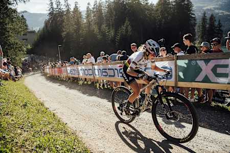 Kate Courtney rides uphill during the XCC race at Rd 6 of the UCI MTB World Cup 2019 in Lenzerheide, Switzerland.