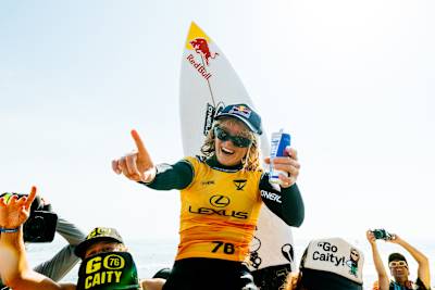 Caitlin Simmers is chaired up the beach after winning the WSL Finals at Lower Trestles.