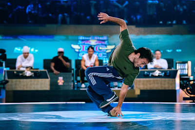 Chey steps through a hole that he creates by grabbing one foot with the hand.