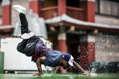 Junior support his weight with one arm and spills water with the other.