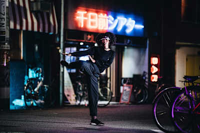 Angyil stands on one leg while dancing.