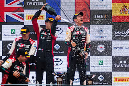 Sebastien Ogier and Julien Ingrassia of Toyota Gazoo Racing celebrate on the podium after winning the World Rally Championship in Monza, Italy.