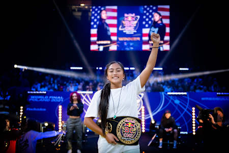 Logistx of the USA celebrates with her winners belts after the Red Bull BC One World Final at Ergo Arena in Gdansk, Poland on November 6, 2021.