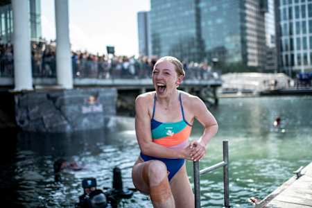 Molly Carlson of Canada reacts after diving from the 21 metre platform during the final competition day of the first stop of the Red Bull Cliff Diving World Series in Boston, USA on June 4, 2022.