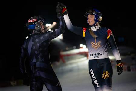 Lindsey Vonn high fives after completing the Streif at night.