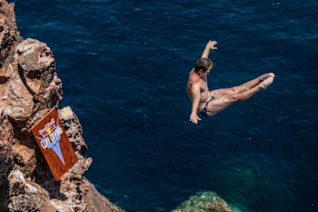Matthew Cooper of the USA dives from the 24 metre rock platform during the first competition day of the first stop of the Red Bull Cliff Diving World Series in Saint Raphael, France on June 11, 2021.