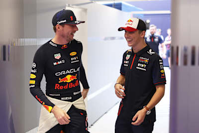 In 2023, Max Verstappen and Liam Lawson of Oracle Red Bull Racing chat in the team garage during final practice for the Spanish F1 Grand Prix in Barcelona