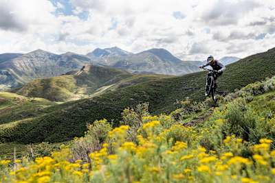 A MTB rider rides through meadowland in Lesotho.