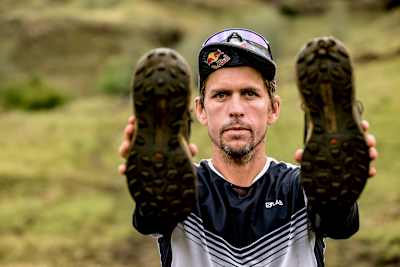 Ryan Sandes showing his trail running shoes used by Trail Running Around Lesotho in April 2022