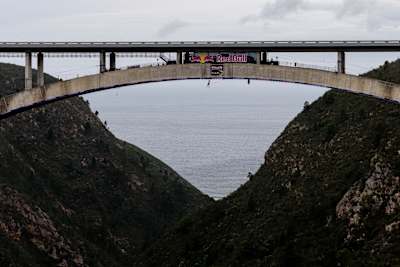 Thomas van Tonder seen crossing the Bloukrans Bridge via monkey bars in South Africa in October 2026. The wide-angle shot gives a full idea of the scale of the crossing.