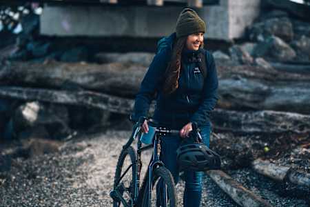 Women's pro cyclist Katie Holden as seen walking with her road bike.