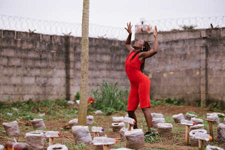 Seyi Oluyole dances outside.