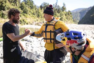 Rob Warner, Matt Jones and Josh James greet each other on a survival camp in the Buller District of New Zealand.
