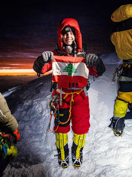 Attar proudly displays the Lebanese flag from the top of K2.