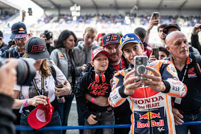 Marc Márquez of Spain takes a selfie with fans during the MotoGP Shark Grand Prix de France at Le Mans, France on May 13, 2023.