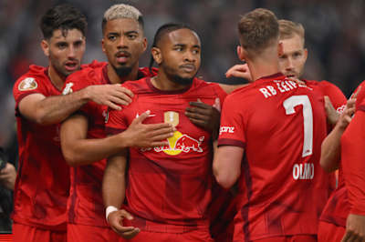 Christopher Nkunku of RB Leipzig celebrates with team mates Dominik Szoboszlai, Benjamin Henrichs, Daniel Olmo and Konrad Laimer after he scored his team's first goal during the DFB Cup final match.