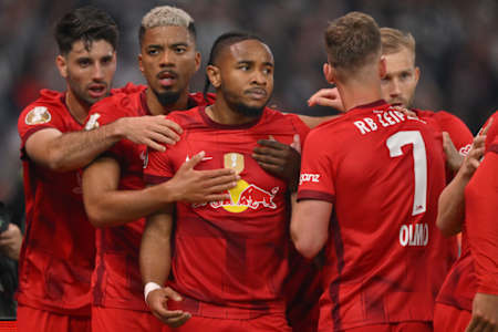 Christopher Nkunku of RB Leipzig celebrates with team mates Dominik Szoboszlai, Benjamin Henrichs, Daniel Olmo and Konrad Laimer after he scored his team's first goal during the DFB Cup final match.