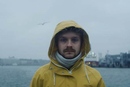 An image of JerAx standing by the sea