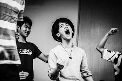 Street Fighter pro John Takeuchi gives an excited fist pump after a win.