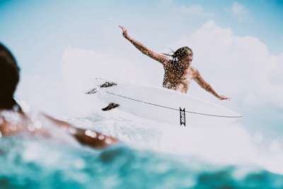 Lizzie Stokely surfing
