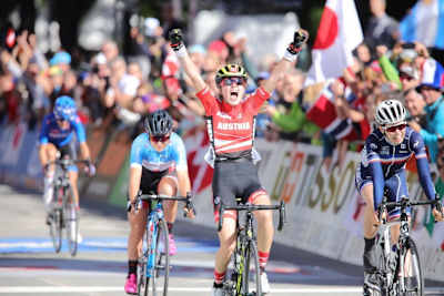 Laura Stigger raises her hands on the finish line after winning the UCI Junior Road Race World Championships in Innsbruck on September 28, 2018.