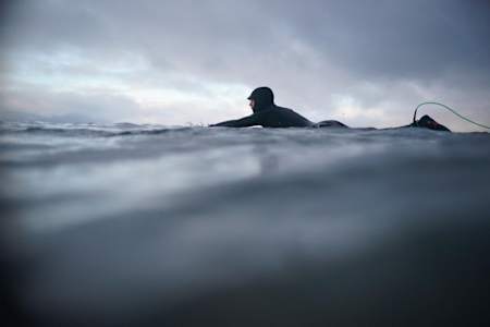 Conor Maguire on his surfboard