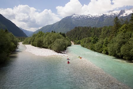 Kayakers paddle into the Soča river in Slovenia.