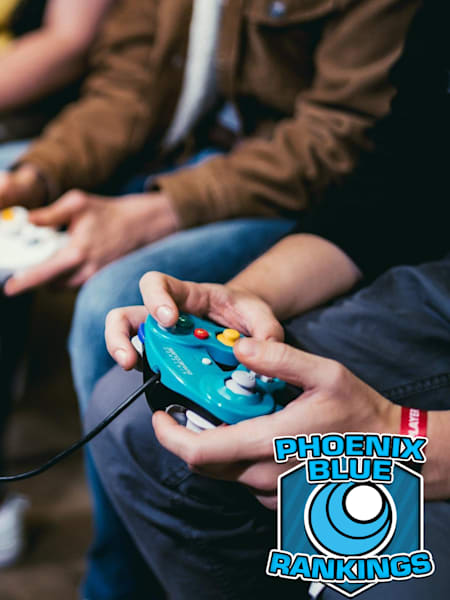 People playing Smash Bros Melee with GameCube controllers