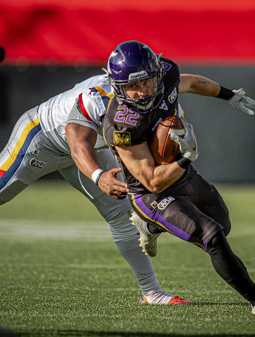 Albert Wiesigstrauch, a Vienna Vikings player, gets tackled while holding the ball by an Alpine Rams player on June 13, 2026, in Vienna, Austria at the American Football League Europe game