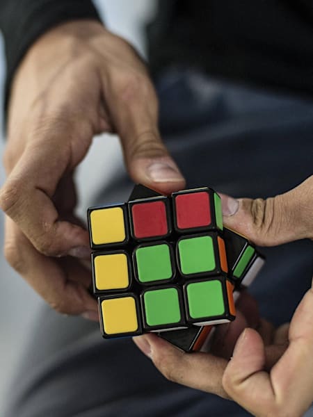A player works on solving a Rubik's Cube.