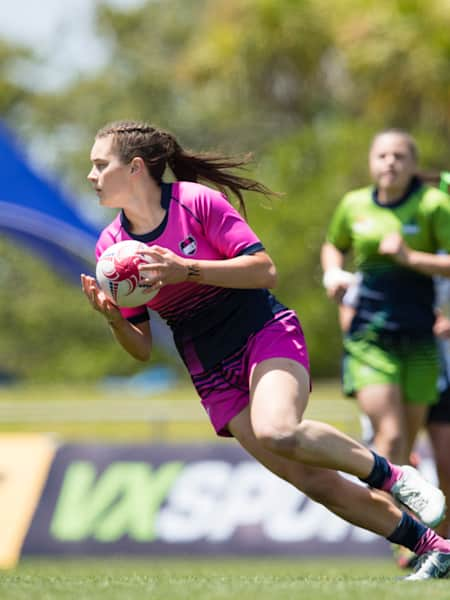 Female players compete in a rugby 7s match.