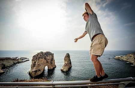 Slackliner Alex Mason warms up in front of the Raouche Rock in Beruit.