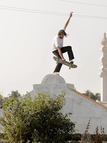Skater Rob Wootton performs a Fastplant in Goa, India.