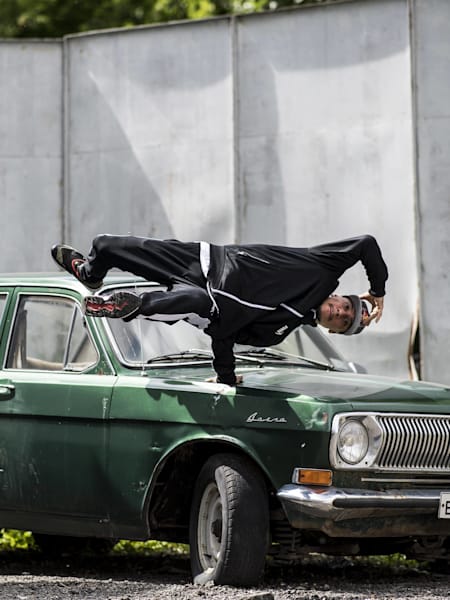 Roxrite Posing with an old Russian car at the Red Bull BC One Russian Cypher in Moscow Russia on June 17, 2017.