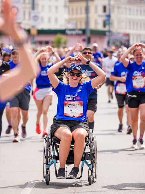Excitement at the 2026 Wings for Life World Run as participants, including wheelchair athletes, make their way through Vienna, Austria, united in support of spinal cord research