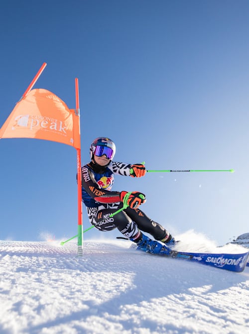 On August 4, 2025, Red Bull athlete Alice Robinson masterfully navigates a slalom gate at Coronet Peak near Queenstown, New Zealand, capturing the thrill of alpine skiing
