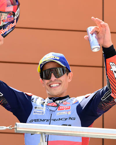 Marc Márquez on the podium celebrates winning first place at Stop 12 of the 2024 MotoGP World Championship in Aragon. 