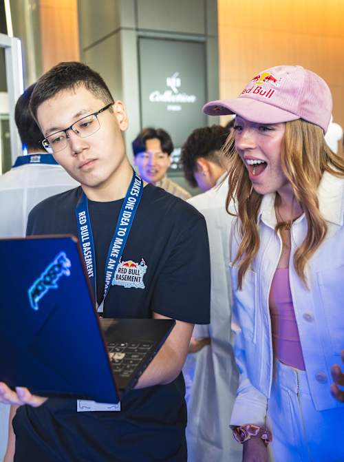 Molly Carlson engages with Kanat Tazhikhan and Sultan Zhumakadyr as project UMIT is showcased at the Red Bull Basement World Final in Tokyo, Japan on December 5, 2024