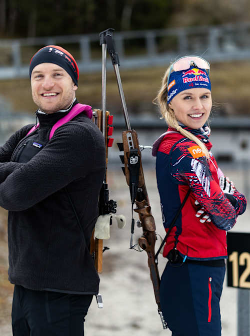 In 2026, Sascha Huber and Red Bull athlete Anna Gandler pose back-to-back with rifles at Seefeld in Tirol, Austria, radiating energy and competitive spirit on the range