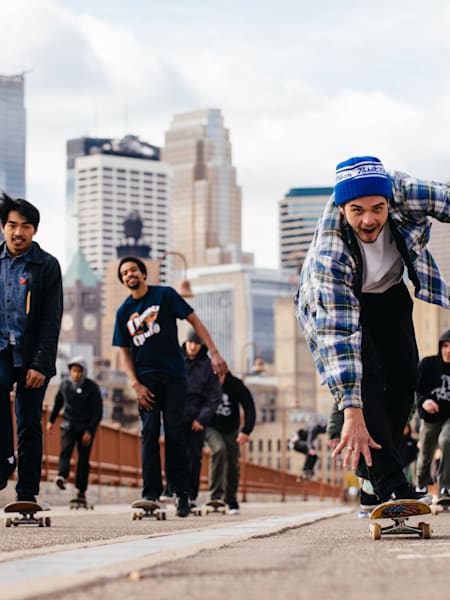 Skaters cross the Stone Arch Bridge for Red Bull Interskate in Minneapolis