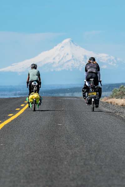 Michelle Parker and Cody Townsend  cycling with trailers during filming of The Mountain Why.