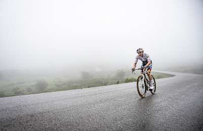 In 2024, Red Bull - BORA - hansgrohe’s Florian Lipowitz rides the misty Covadonga finish climb in Spain during stage 16 of La Vuelta, wearing the white best young rider jersey.